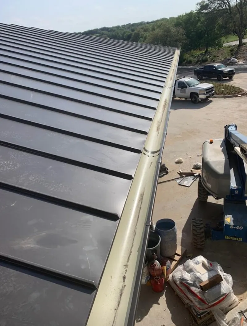Standing seam panel and gutter detail on a metal roofing jobsite in Tonawanda